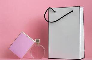 Perfume bottle from a pink box on an isolated background with mockup and copyspace photo