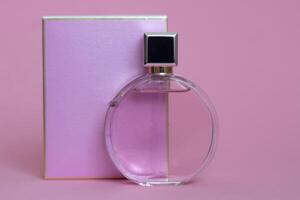 Perfume bottle from a pink box on an isolated background with mockup and copyspace photo