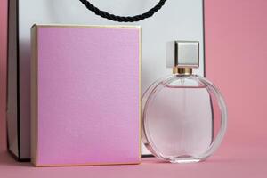 Perfume bottle from a pink box on an isolated background with mockup and copyspace photo