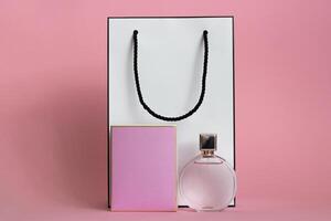 Perfume bottle from a pink box on an isolated background with mockup and copyspace photo