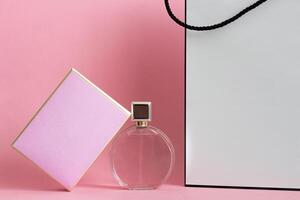Perfume bottle from a pink box on an isolated background with mockup and copyspace photo