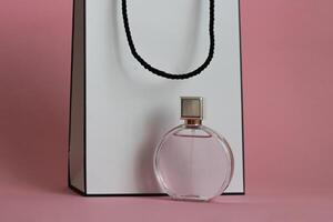 Perfume bottle from a pink box on an isolated background with mockup and copyspace photo