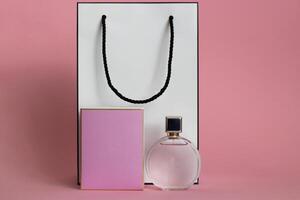 Perfume bottle from a pink box on an isolated background with mockup and copyspace photo