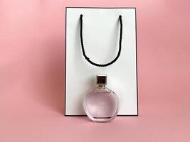 Perfume bottle from a pink box on an isolated background with mockup and copyspace photo