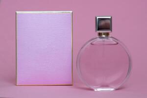 Perfume bottle from a pink box on an isolated background with mockup and copyspace photo