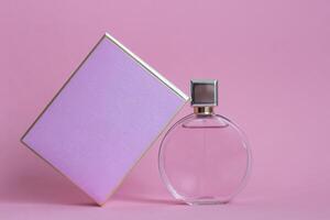 Perfume bottle from a pink box on an isolated background with mockup and copyspace photo