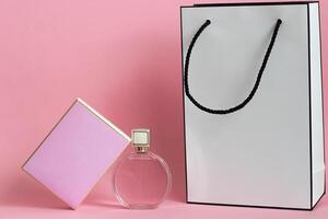 Perfume bottle from a pink box on an isolated background with mockup and copyspace photo