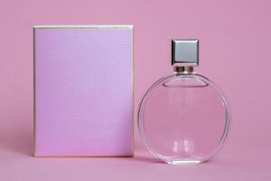 Perfume bottle from a pink box on an isolated background with mockup and copyspace photo