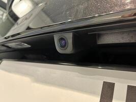 Rear view camera with washer installed on the car photo