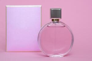 Perfume bottle from a pink box on an isolated background with mockup and copyspace photo