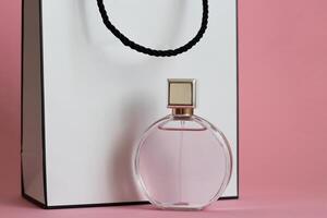 Perfume bottle from a pink box on an isolated background with mockup and copyspace photo