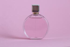 Perfume bottle from a pink box on an isolated background with mockup and copyspace photo