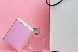 Perfume bottle from a pink box on an isolated background with mockup and copyspace photo