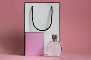Perfume bottle from a pink box on an isolated background with mockup and copyspace photo