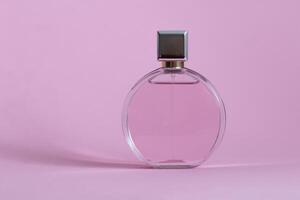 Perfume bottle from a pink box on an isolated background with mockup and copyspace photo