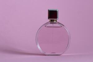 Perfume bottle from a pink box on an isolated background with mockup and copyspace photo