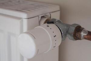 Adjusting the radiator temperature using a thermostat in an apartment with central heating photo