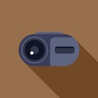 Digital camera lying on a brown surface with long shadow vector