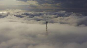 Upper part of broadcasting tower captured from above amidst fog video