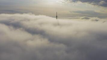Broadcasting tower's upper part seen from above in the fog video