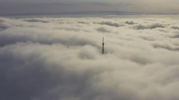 Aerial shot of broadcasting tower's upper part in the fog video