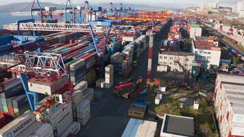 Reach stacker loading a container onto a car trailer at a container terminal video