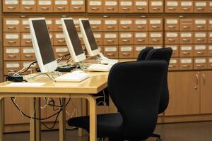 computer terminals in a modern library with blurred catalog cabinets in the background photo