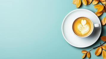 Cup of coffee on blue background with autumn leaves. photo