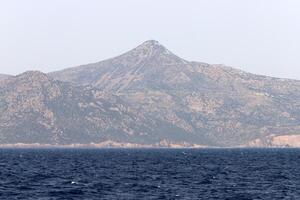 View from the deck of a steamship on a small island in the Aegean Sea. photo