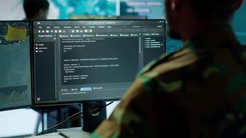 Military specialist in a high tech control center managing satellite radar surveillance, collecting intelligence on cctv systems. Interpreting real time data to ensure national defense. Camera A. video