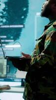 Vertical Military team manages cybersecurity operations in a high tech control center base of operations, managing data protection and surveillance systems, safeguarding national security. Camera A. video