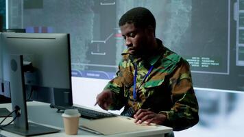Military personnel in a control center working on data processing, integrating real time surveillance and security protocols essential for national defense and strategic operations. Camera A. video