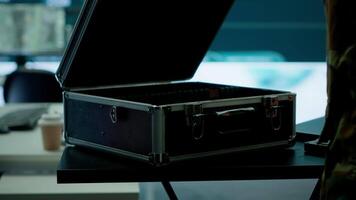 Government intelligence expert works on laptop in a command center to manage surveillance operations, collecting real time data for security measures. Protecting national interests for efficiency. Camera A. video