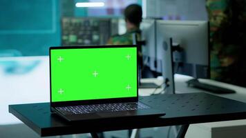 Army IT expert in control center collecting real time battlefield data, process satellite surveillance imagery for successful military defense mission. Using green screen isolated display. Camera A. video