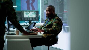 Army intelligence specialists using advanced computer systems and satellite data to enhance national security, critical information. Soldiers planning for mission in high tech control room. Camera A. video