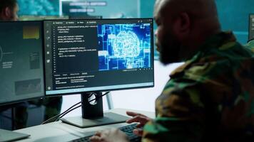 Machine learning specialist monitors satellite data and neural network to collect data for operations. Programming algorithms for cybersecurity and national safety, AI brain visualization. Camera A. video