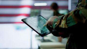 US soldiers in a cyber control center engaging in cybersecurity operations, handles classified information and ensures security of state secrets and government data. Surveillance footage. Camera A. video