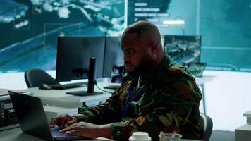 Team of military professionals in control center monitors satellite intelligence, collecting real time information and transmitting details for a mission success. Decision making. Camera A. video