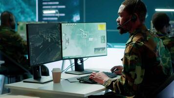 Army intelligence specialist utilize advanced computer systems, surveillance technology and data to enhance national security. Working in a command post against potential threats. Camera A. video