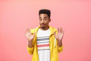 Guy staying out of troubles. Portrait of confused unsure clueless african american guy with beard raising palms in surrender gazing innocent at camera denying everything being unvinvolved photo