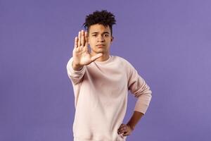 Stop right there, keep distance dont come closer. Portrait of serious-looking young sound-minded hispanic guy trying prevent something bad, show warning gesture, prohibit or forbid photo