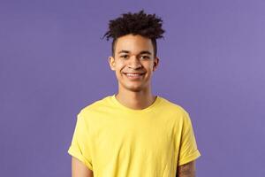 Close-up portrait of smiling, enthusiastic hispanic male student searching job, consider career opportunities, recruiting to company, smiling cheerful standing purple background photo
