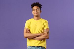 Close-up portrait of arrogant, proud and boastful young smart guy cross hands over chest in confident, self-assured pose, smirk and look mighty, feel like he knows everything, purple background photo