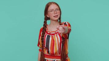 Redhead girl pointing to camera and looking with playful happy expression, making choice, hey you video