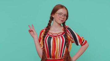 Redhead lovely girl showing victory sign, hoping for success and win, doing peace gesture, smiling video