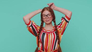 Lovely funny redhead girlsmiling friendly and doing bunny ears gesture on head, having fun, fooling video