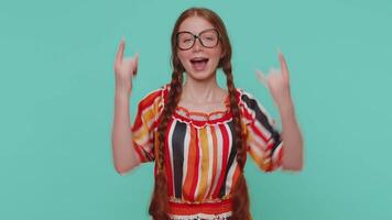 Overjoyed happy girl showing rock n roll gesture by hands, cool sign, shouting yeah with crazy face video