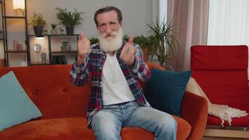 Senior man showing thumbs up, nodding in approval, successful good work satisfaction results at home video