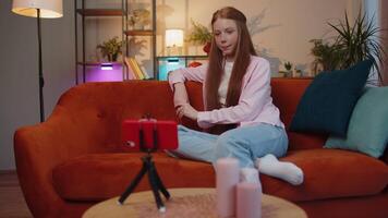 Child girl blogger taking selfie on smartphone communicating call home online with subscribers video