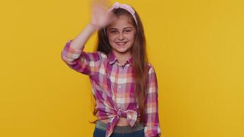 Happy child girl kid smiling friendly at camera, waving hands gesturing hello, hi, greeting, goodbye video
